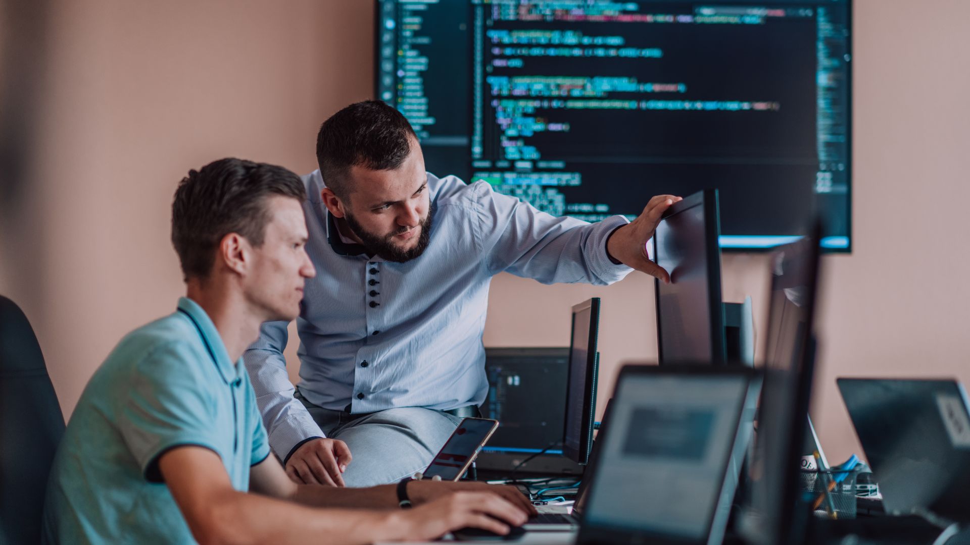 Two men looking at a computer monitor